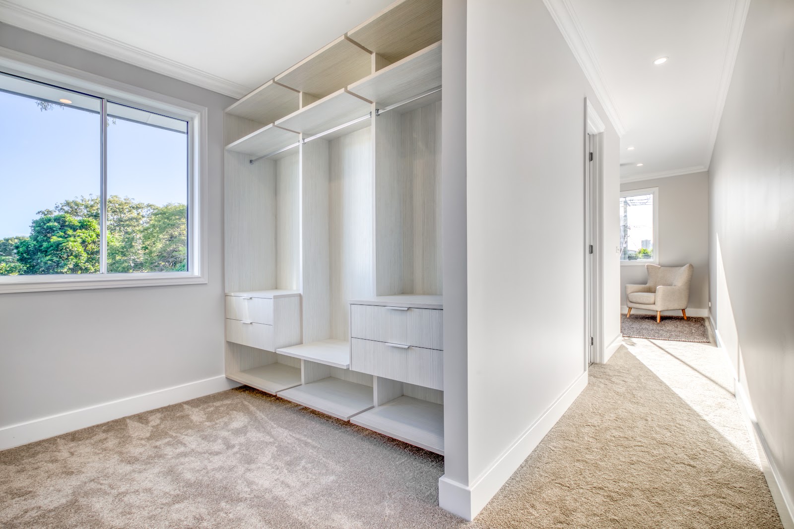 Walk-in wardrobe fit-out with open shelving, hanging space and drawers